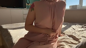 A Woman In A Pink Dress Explores Her Sensual Desires